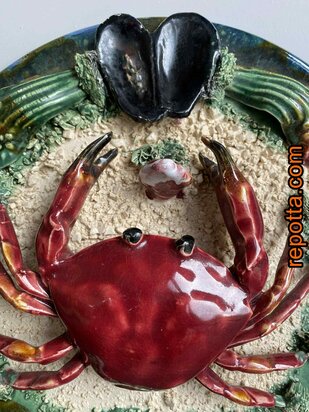  majolica bord met zeekrab tussen zand en schelpen 