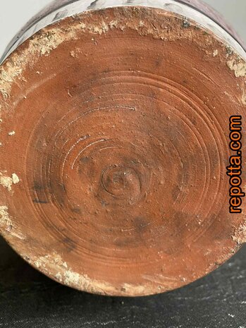 vintage kruik met persoon in kleermakerszit